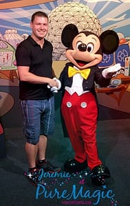 Jeremie shacking hands and posing for a picture with Mickey Mouse