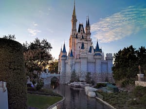The side of Cinderella Castle at dusk reflecting in the mote.